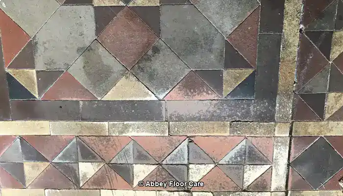Why Victorian Mosaic Tiles Fade and What Causes Surface Dulling. Example of Victorian Clay Tile Floor dulled through surface wear and damage