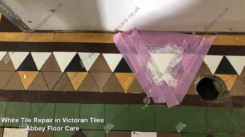 White replacement Victorian tile fitted into a missing hallway section